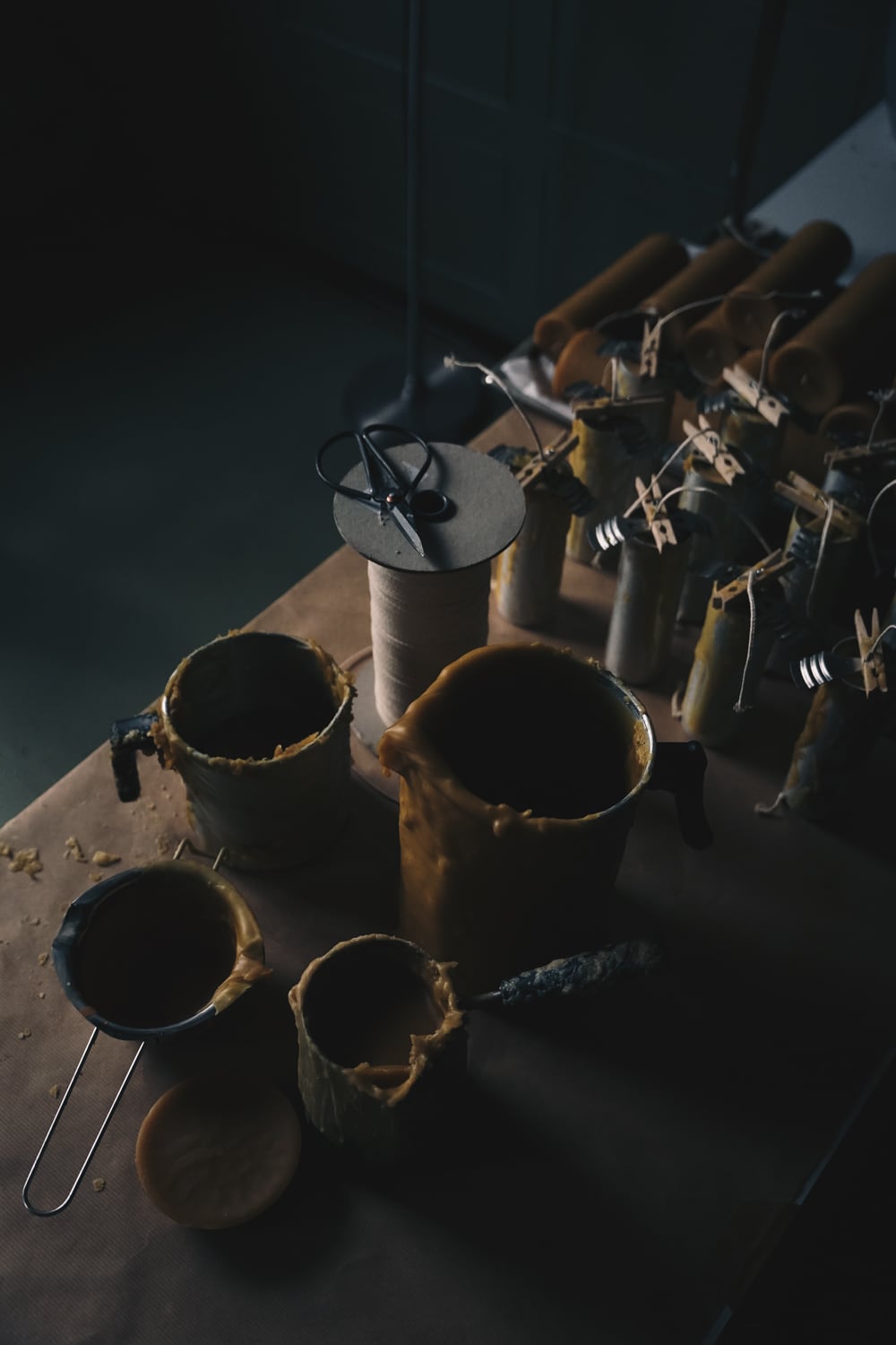 Pouring jugs and and beeswax pillar candles being made