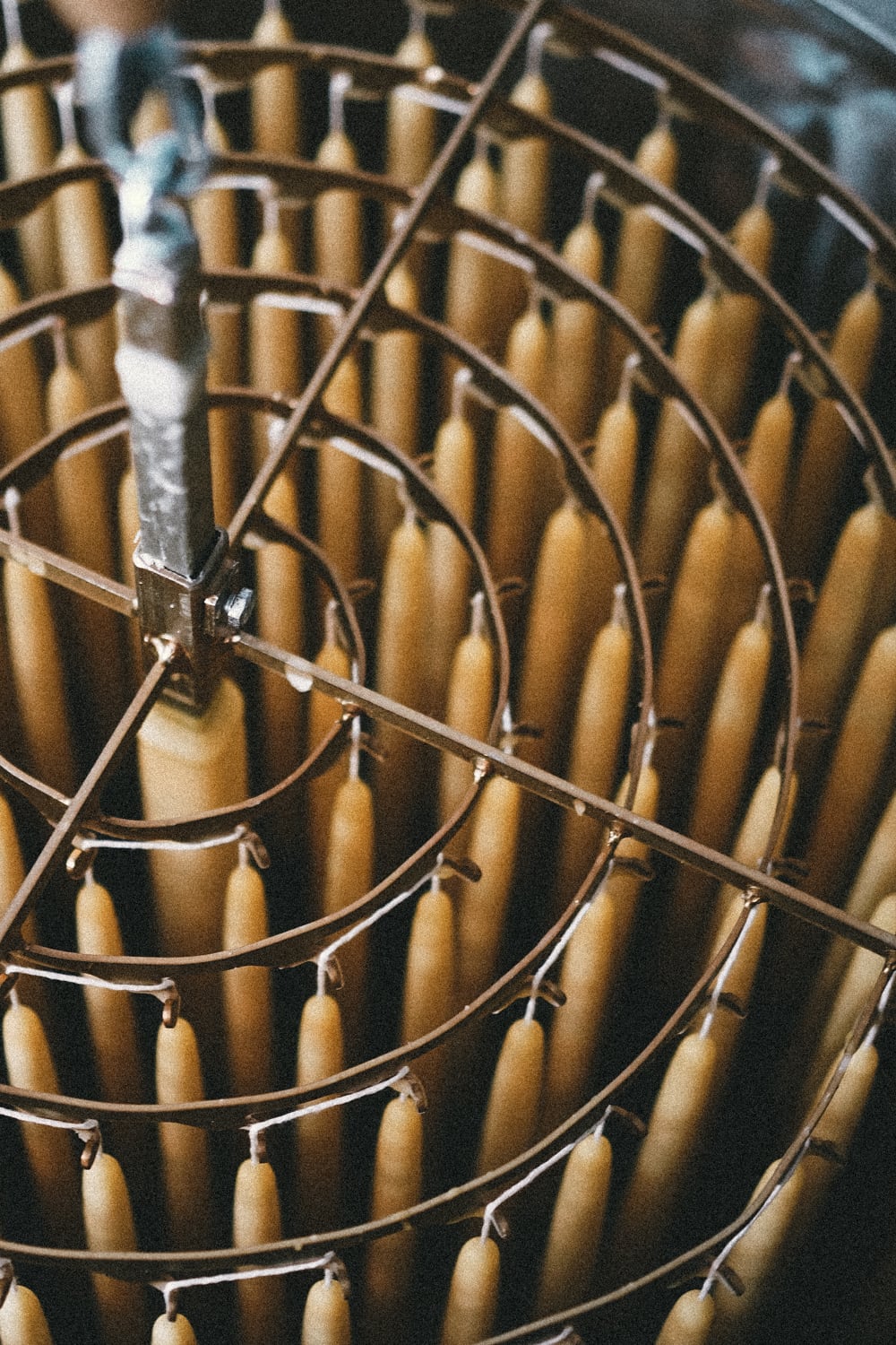 dipping basket from above with beeswax dinner candles being dipped